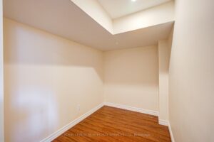 Finished basement bonus room with hardwood flooring and flexible living space.