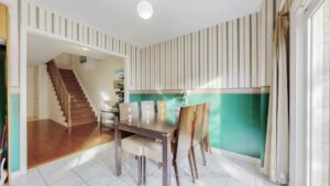 Dining room with open sightlines to the foyer and staircase.