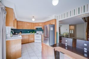 Spacious kitchen with wood cabinetry, breakfast bar, and open-concept layout.