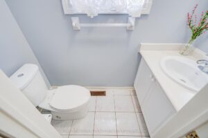 Main-floor powder room with pedestal vanity and contemporary finishes.