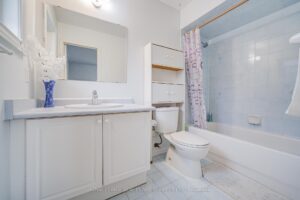Four-piece bathroom with extended vanity and tub-shower combination.