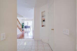 Bright front foyer with ceramic tile flooring leading into the open-concept living area.
