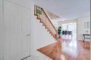 Open-concept main floor with hardwood flooring, staircase, and spacious living area.