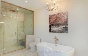 Spa-inspired bathroom with freestanding soaker tub, glass shower, and double vanity.