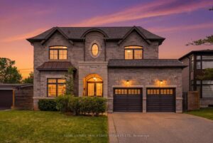 Twilight view of the luxury home's front exterior with professional landscaping and architectural lighting.
